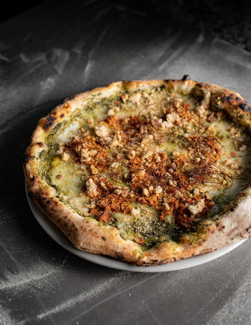 La Scostumata con vellutata di friarielli, pulled pork, tarallo sbriciolato e fili di peperoncino